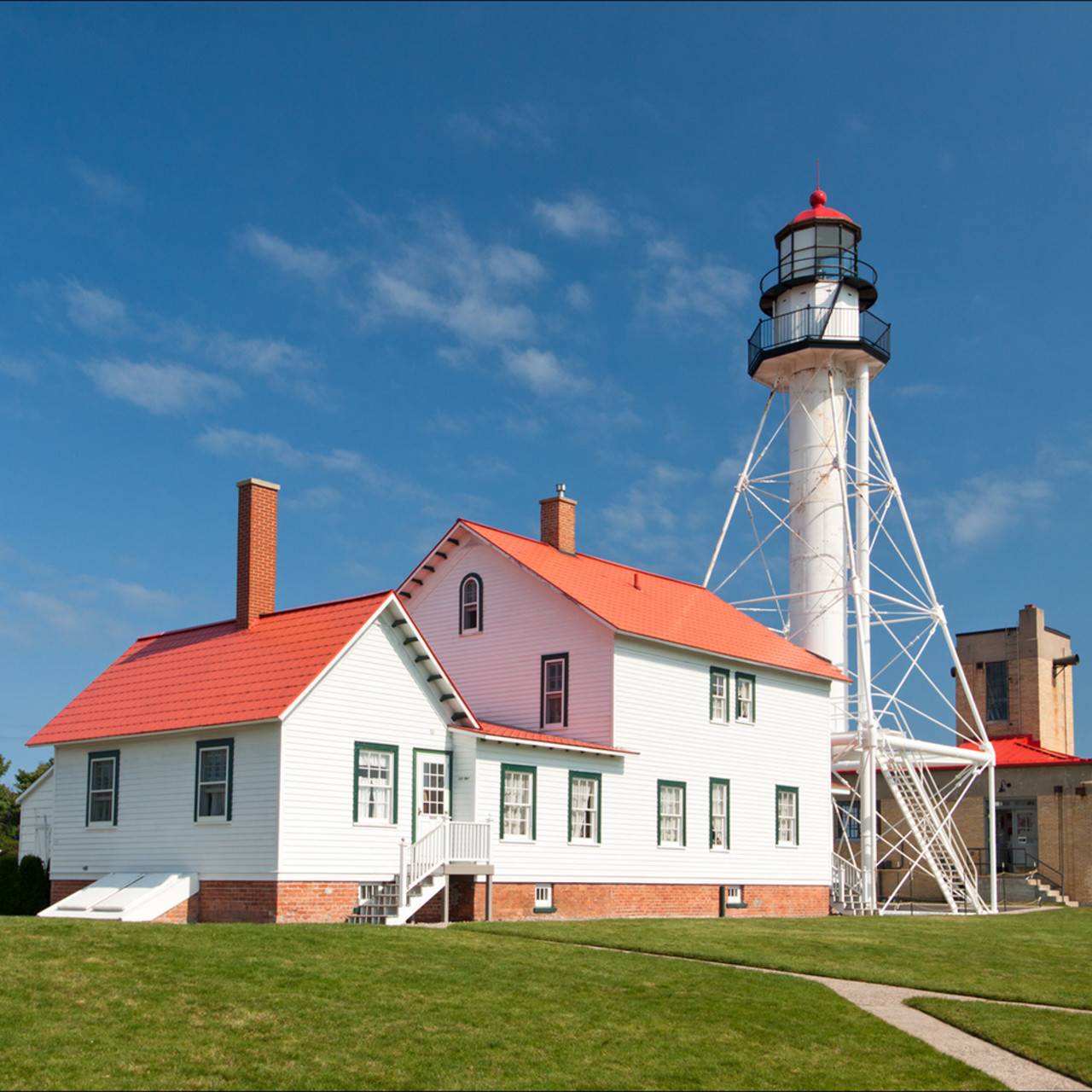 Upper peninsula lighthouse, specifically the whitefish point lighthouse building in summer.