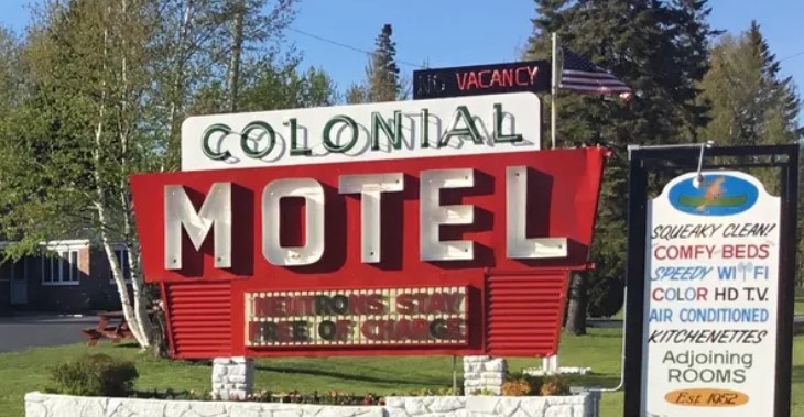 Street sign of the Colonial Motel in Manistique, Michigan.