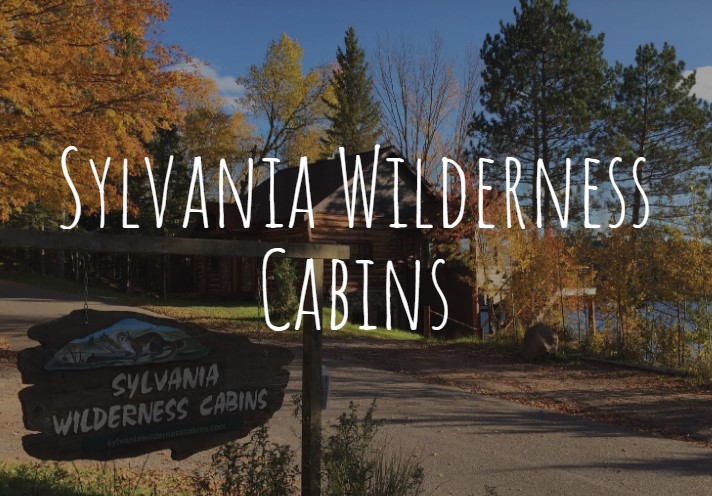 Sylvania Wilderness Cabins front page logo overlaying a picture of the streetview of the cabins.