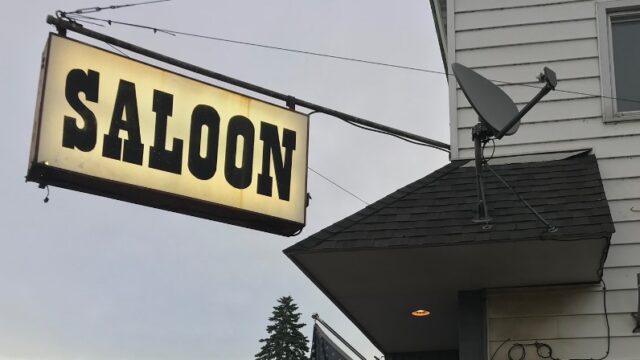 The Saloon sign hanging on the storefront.