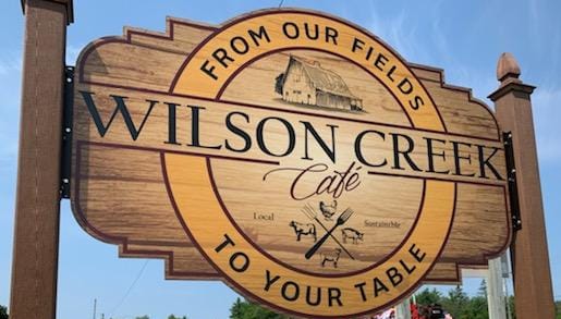 Wilson Creek Cafe street sign. From our fields to your table.